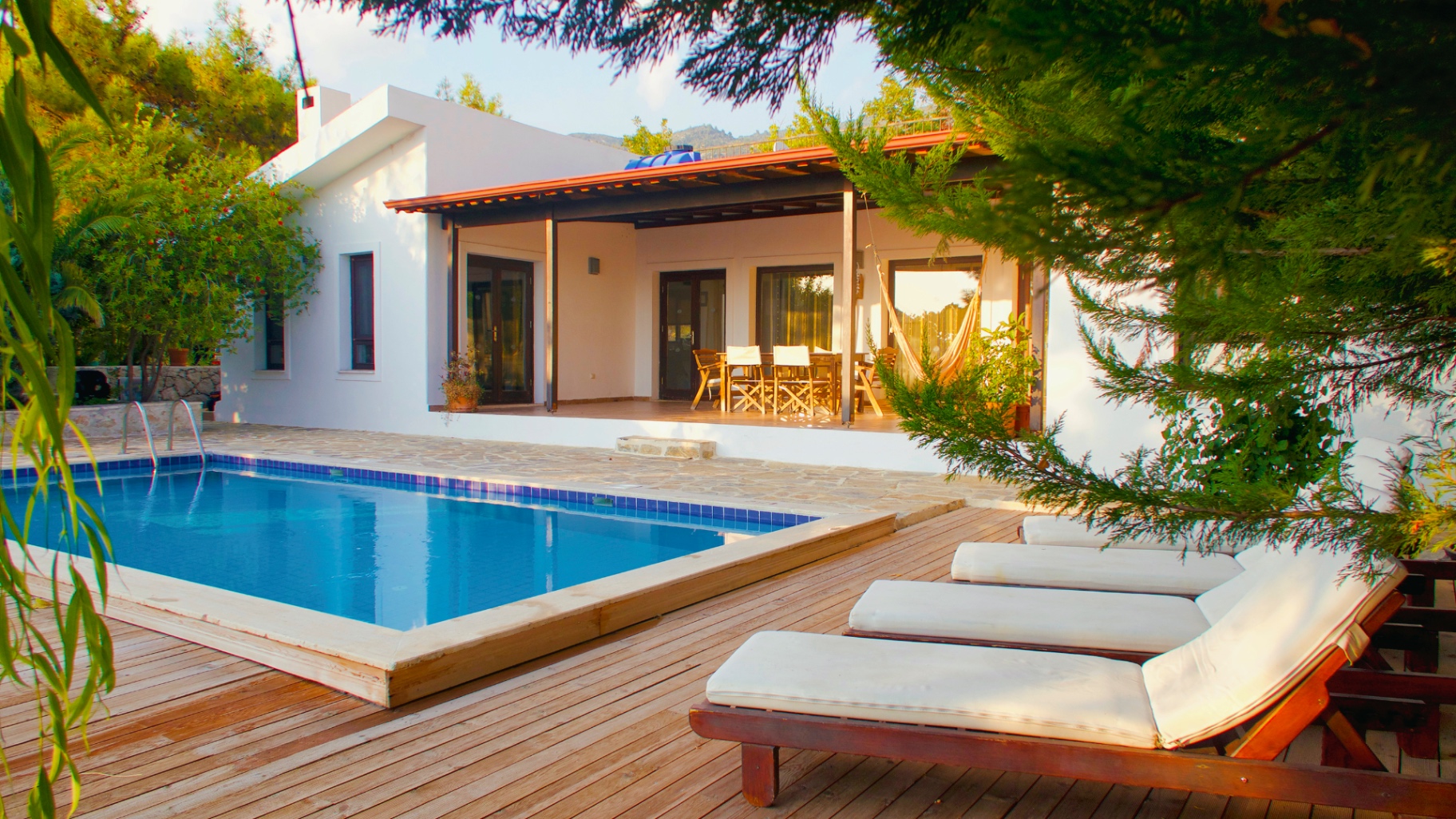 Villa front with pool at golden hour